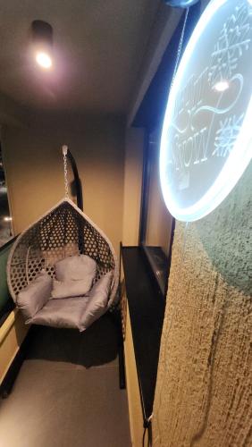 a room with a swing with a sign on the wall at WinterHome2 in Bjelašnica