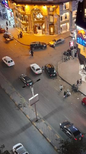 a group of cars parked on a city street at Seuiet Hs شهاب in Cairo