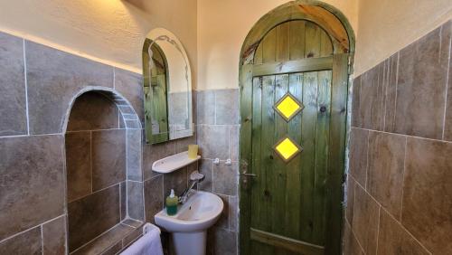 a bathroom with a green door and a sink at Siwa Salt Lake Lodge in Siwa