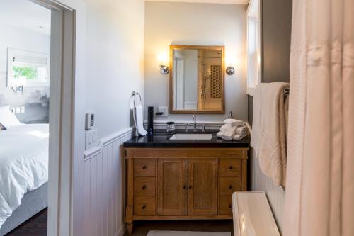 a bathroom with a sink and a mirror at Brannan Cottage Inn in Calistoga