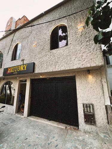 a building with two garage doors on the side of it at History Center Hotel in Medellín