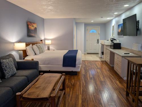 a hotel room with a bed and a couch at The Waterfront at Potlatch in Shelton