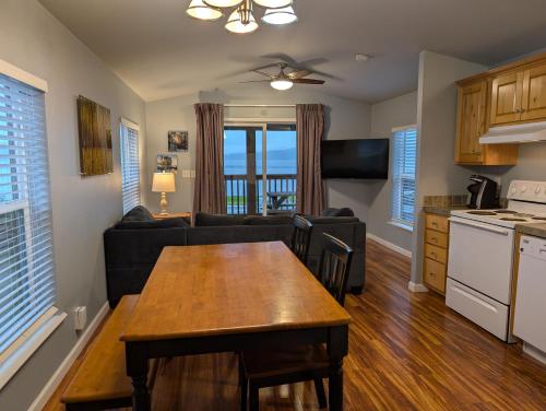 a kitchen and living room with a table and a couch at The Waterfront at Potlatch in Shelton