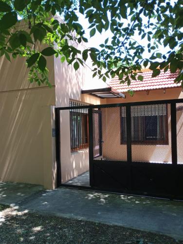 a black gate in front of a building at The House II in City Bell