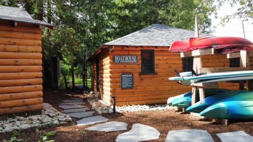 a small log cabin with a sign on it at Haliburton Post House in Minden