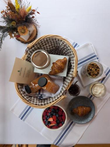 a table with a basket of food and other foods at Haliburton Post House in Minden