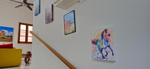 a hallway with paintings on the wall at 3 Floors Villa on Promenade 4 bedrooms 3 bathrooms V1 in Sliema