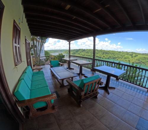 an outdoor patio with tables and chairs on a balcony at Hotel Casablanca Boutique Ciudad del Este By Swiss Bonmont Hotels in Ciudad del Este