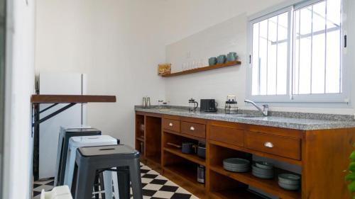 a kitchen with a large sink and a window at Balcon de la virgen in Luján