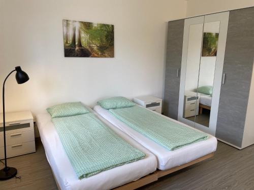 a bedroom with two beds and a mirror at Riviera by Fewotessin in Vira