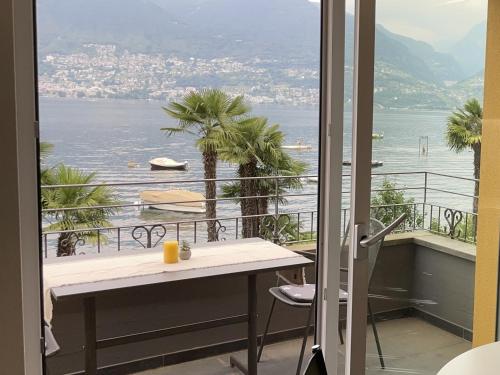 a balcony with a table and a view of the water at Riviera by Fewotessin in Vira