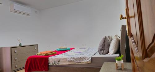 a bedroom with a bed with a red blanket on it at 3 Floors Villa on Promenade 4 bedrooms 3 bathrooms V1 in Sliema