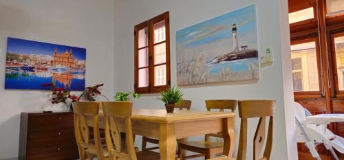 a dining room with a wooden table and chairs at 3 Floors Villa on Promenade 4 bedrooms 3 bathrooms V1 in Sliema