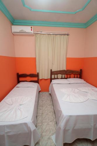 Ένα ή περισσότερα κρεβάτια σε δωμάτιο στο Hotel Minas Brasil