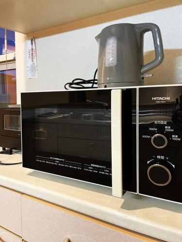 a microwave sitting on top of a kitchen counter at 清里札弦Arun別邸 in Kiyosato