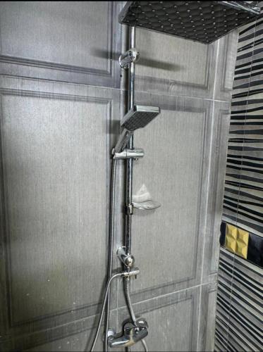 a shower in a bathroom with a shower curtain at Apartment in martil in Martil