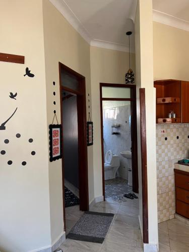 a room with a bathroom with a toilet in it at Jolta Inn in Kampala