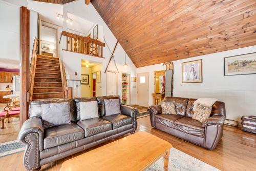 a living room with leather couches and a wooden ceiling at Rustic Intervale Hideaway with Deck and Wooded Views! in Intervale