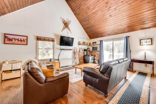 a living room with leather furniture and a wooden ceiling at Rustic Intervale Hideaway with Deck and Wooded Views! in Intervale