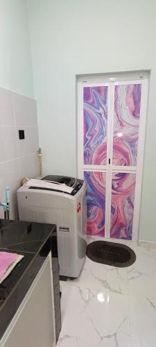 a printer in a kitchen with a painting on the wall at Lemongrass Field Homestay in Setiu