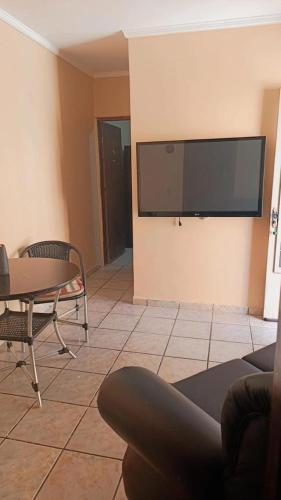 a living room with a large flat screen tv on the wall at Pousada Beira Rio Barreiras in Barreiras