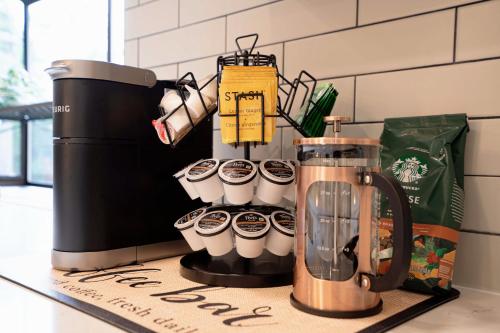 a group of coffee cups sitting on top of a counter at Spacious Modern Retreat w Game Room and Yard in Lynnwood