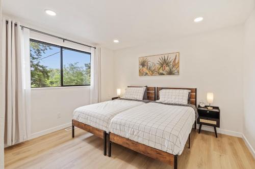 a white bedroom with a bed and a window at Spacious Modern Retreat w Game Room and Yard in Lynnwood