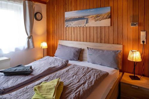 a bedroom with a bed in a wooden wall at Huus Jan in Spiekeroog