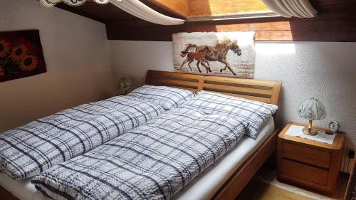 a bed with a blue and white comforter in a bedroom at Apartment Birkenstrasse 54 Engelberg in Engelberg