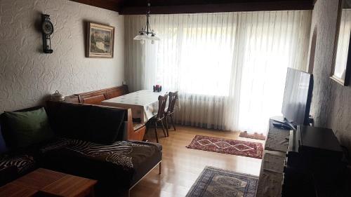 a living room with a table and a dining room at Apartment Birkenstrasse 54 Engelberg in Engelberg