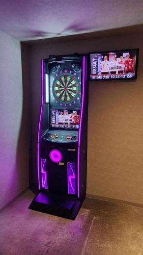 a video game machine in a room with purple lighting at Guest House Inawashiro~Hanbog~ in Inawashiro