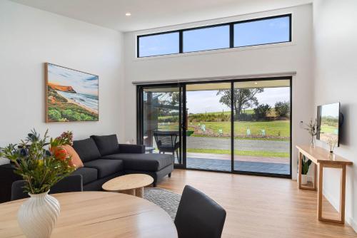 a living room with a couch and a table at The Gap Retreat in Cowes