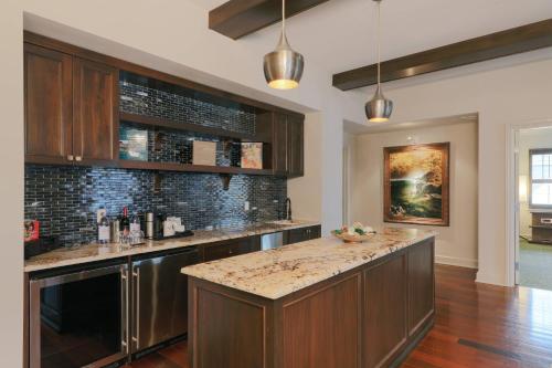 a kitchen with wooden cabinets and a counter top at Grand Bohemian Mountain Brook, Autograph Collection in Birmingham