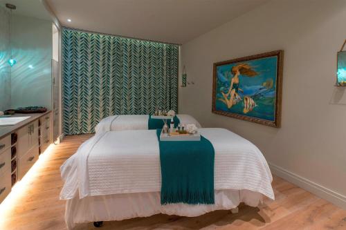 a bedroom with a large bed and a sink at Grand Bohemian Mountain Brook, Autograph Collection in Birmingham
