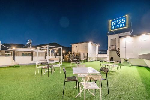 a group of tables and chairs on a grass field at GijangYeonhwari No,25 Hotel in Busan