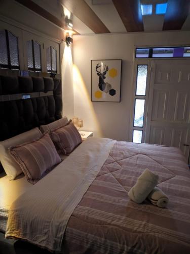 a bedroom with a large bed with a headboard at Hotel Restaurante LA AZOTEA in El Cerrito