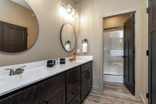 a bathroom with a sink and a mirror at Branson 10 Bedroom Lakeside Lodge! PRIVATE HEATED POOL! in Hollister