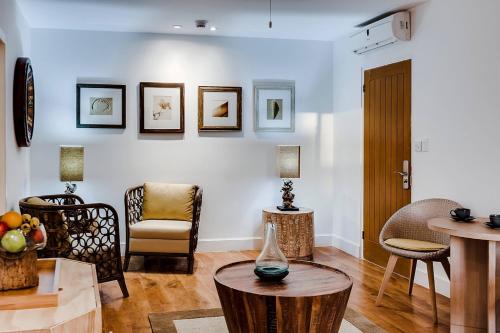 a living room with chairs and a table at Waves Resort & Spa, Barbados, An Autograph Collection All-Inclusive Resort in Saint James