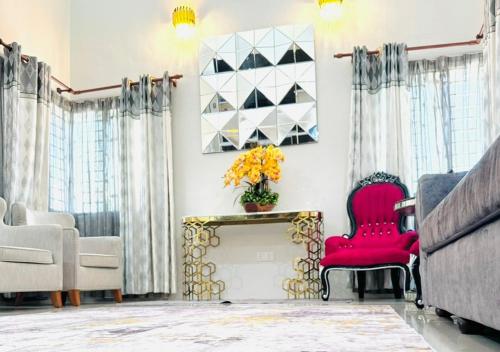 a living room with a red chair and a fireplace at Tiny House Dferry With Private Pool OR 4 Room Homestay Jerantut Wifi Full Aircond in Jerantut