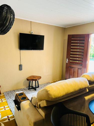 a living room with a couch and a flat screen tv at Complexo Turístico Gruta da Serra in Guaramiranga