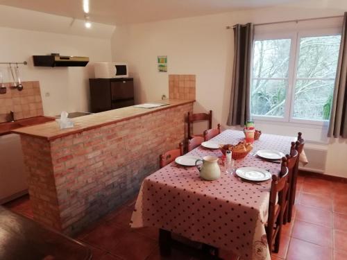a dining room with a table and a kitchen at Apartment in Quend near the Sea in Quend