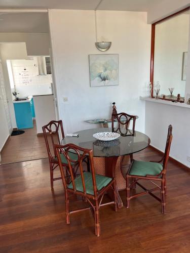 a dining room with a table and chairs at La résidence du sportif Bernard in Anse-Bertrand
