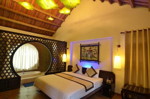 a bedroom with a large bed and a bath tub at Viet House Yen Duc Village in Tử Lạc