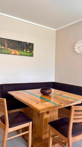 a dining room table with a bowl on top of it at Channers on Norfolk in Burnt Pine