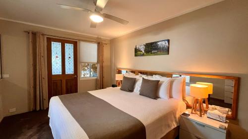 a bedroom with a large bed and a ceiling fan at Channers on Norfolk in Burnt Pine