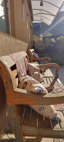 a row of wooden benches sitting on a patio at Zen Pousada in Telêmaco Borba