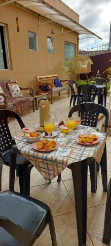 a table with plates of food on it at Zen Pousada in Telêmaco Borba