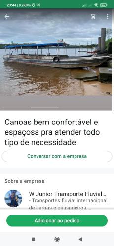 a page of a website with a boat on the water at Wanderley in Oiapoque