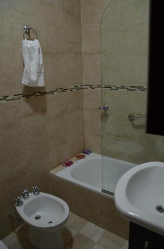 a bathroom with a sink and a tub and a toilet at Carlos 1° in Salta