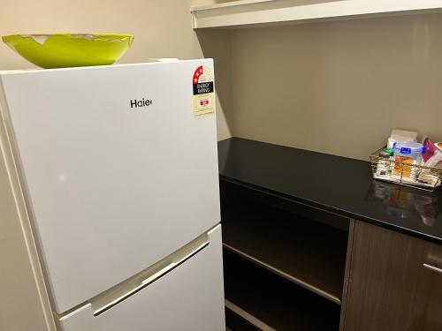 a white refrigerator in a kitchen next to a counter at Ararat in Tarneit
